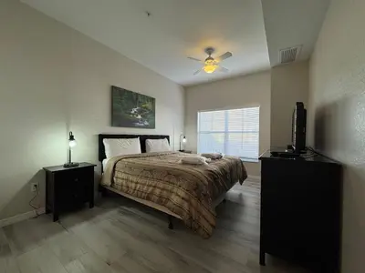 a bedroom with a bed and a ceiling fan at 3 Bedroom 2 Bathroom Villas At SevenDwarfs 27-106 in Kissimmee