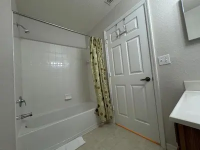 a bathroom with a shower and a tub and a sink at 3 Bedroom 2 Bathroom Villas At SevenDwarfs 27-106 in Kissimmee