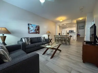 a living room with a couch and a table at 3 Bedroom 2 Bathroom Villas At SevenDwarfs 27-106 in Kissimmee