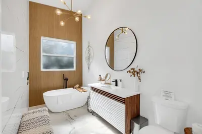 a bathroom with a sink and a mirror at Florida HappyNest Secluded Luxury Guesthouse in Kissimmee