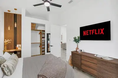 a living room with ametix sign on the wall at Florida HappyNest Secluded Luxury Guesthouse in Kissimmee