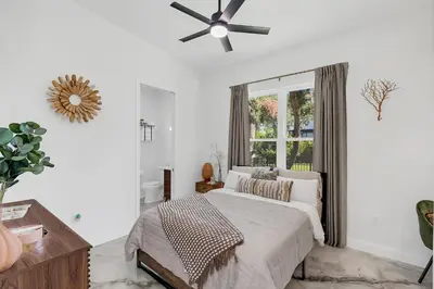 a bedroom with a bed and a ceiling fan at Florida HappyNest Secluded Luxury Guesthouse in Kissimmee