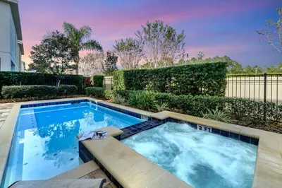 a swimming pool in the backyard of a house at Luxe Family Escape at Encore at Reunion in Orlando