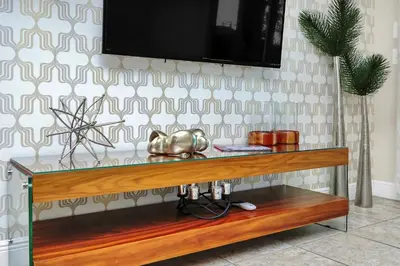 a table with a television on a wall at Luxe Family Escape at Encore at Reunion in Orlando