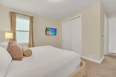 a bedroom with a white bed and a window at Luxe Family Escape at Encore at Reunion in Orlando