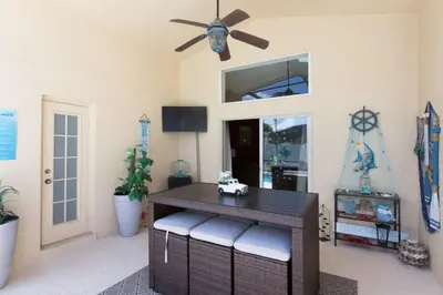 a dining room with a table and a ceiling fan at Indian Creek Vacation Home Close to Disney villa in Orlando