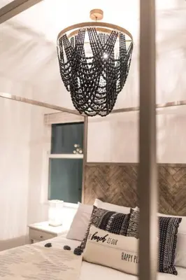a bedroom with a bed and a chandelier at Dream Vacation Home with Lake View, Pool, more, and Walking Distance to Resort in Kissimmee