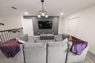 a living room with a couch and a tv at Dream Vacation Home with Lake View, Pool, more, and Walking Distance to Resort in Kissimmee