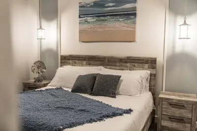 a bedroom with a bed with a blue rug on it at Dream Vacation Home with Lake View, Pool, more, and Walking Distance to Resort in Kissimmee