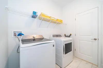 a washer and dryer in a white laundry room at 4338JE VILLA 5 BED/5 BA in Kissimmee
