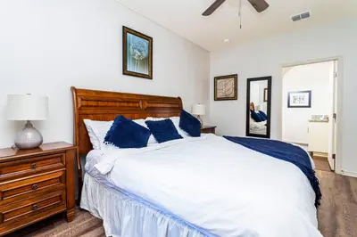 a bedroom with a large bed with blue pillows at happy place in Kissimmee