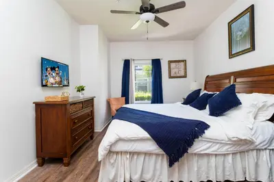a bedroom with a bed and a ceiling fan at happy place in Kissimmee