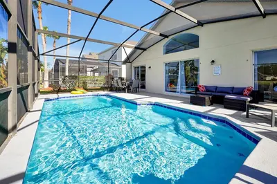 a swimming pool in the middle of a house at Lake Berkley Home: Pool, Lakefront & near Disney in Kissimmee