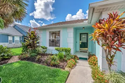 a home with a blue house at 10 Min from Disney Themed 2 Bd Private Pool in Orlando