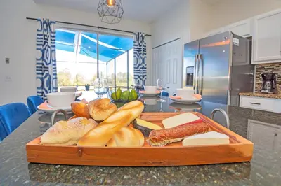 a tray of bread and vegetables on a counter in a kitchen at The Ultimate Family Getaway in Kissimmee
