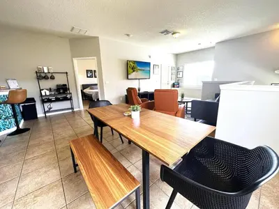a living room with a wooden table and chairs at Amazing! Disney 7 Min, Walmart 1 min, 3 Bed 2 bt in Orlando