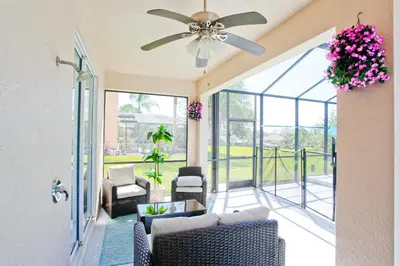 a living room with chairs and a ceiling fan at PN Orlando Vacation Home in Kissimmee