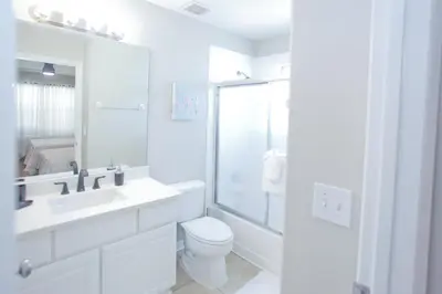 a white bathroom with a sink and a toilet at PN Orlando Vacation Home in Kissimmee