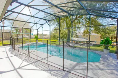an image of a swimming pool in a glass house at PN Orlando Vacation Home in Kissimmee