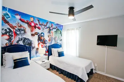a bedroom with two beds and a superhero mural at PN Orlando Vacation Home in Kissimmee