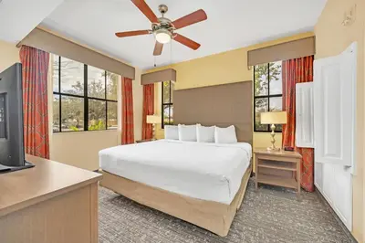a bedroom with a bed and a flat screen tv at Orlando Getaway at Floridays Resort in Orlando