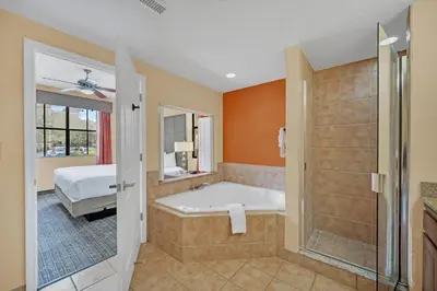 a bathroom with a tub and a bed and a shower at Orlando Getaway at Floridays Resort in Orlando