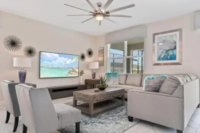 a living room with a couch and a tv at 9 Bed Home Pool Best Location Storey Lake in Kissimmee