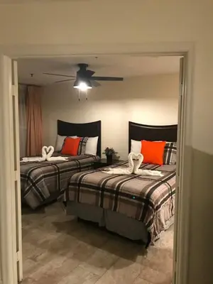 a bedroom with two beds and a ceiling fan at Nice 2 Miles from DISNEY Condo 1 Bedroom 1 Bath in Orlando
