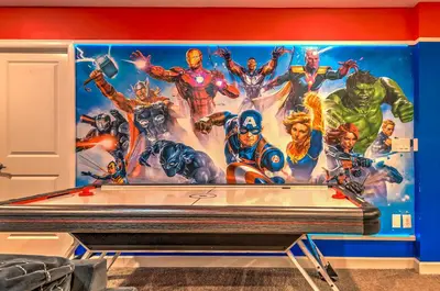 a mural of avengers on a wall at 2852 Ultimate Retreat for your family 9 Bedrooms in Kissimmee