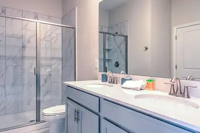 a bathroom with two sinks and a shower at 2852 Ultimate Retreat for your family 9 Bedrooms in Kissimmee
