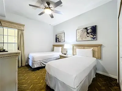a hotel room with two beds and a ceiling fan at Spacious 3 Bed 3 Bath Luxury Condo 5 min from Disney in Orlando