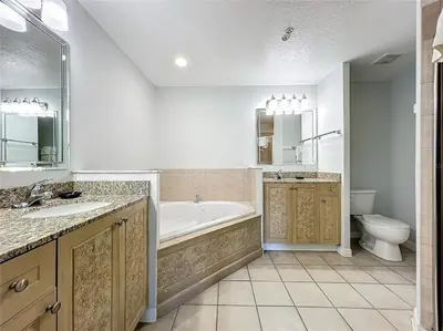 a bathroom with a tub and a sink and a toilet at Spacious 3 Bed 3 Bath Luxury Condo 5 min from Disney in Orlando