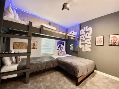 a bedroom with a bunk bed with a ladder at Luxury 6 Bedroom 5 bath poolHome 214 in Orlando