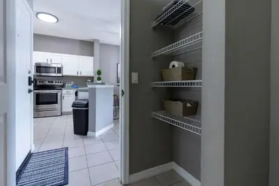 a kitchen with a pantry with baskets on the shelves at Cozy Family 3BR Townhouse Perfect Stay for 6 Guests in Kissimmee