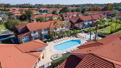an aerial view of a house with a swimming pool at Cozy Family 3BR Townhouse Perfect Stay for 6 Guests in Kissimmee