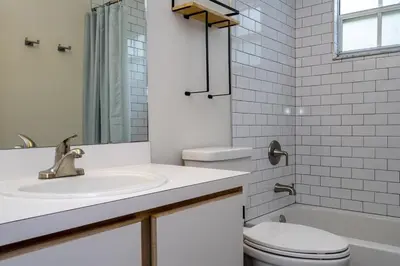 a white bathroom with a sink and a toilet at Family Apt very close to Disney in Kissimmee