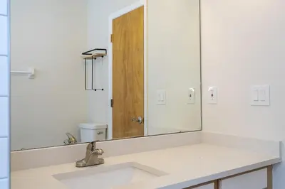 a bathroom with a sink and a large mirror at Family Apt very close to Disney in Kissimmee