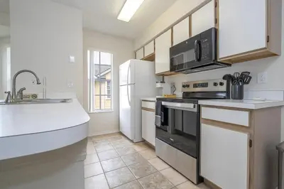 a kitchen with a sink and a stove top oven at Family Apt very close to Disney in Kissimmee