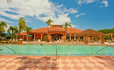 a resort with a swimming pool in front of a building at Luxury 4 bedroom 3 bath pool Home 283 in Kissimmee