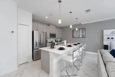 a kitchen with a large white island in a room at Luxury 4 bedroom 3 bath pool Home 271 in Kissimmee