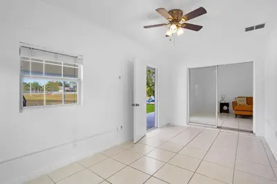 a living room with a ceiling fan and a couch at APluSS Getaway in Kissimmee