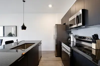 a kitchen with a sink and a microwave at Brand new townhouse in The Hub in Kissimmee