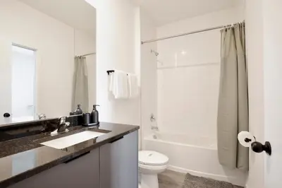 a white bathroom with a sink and a toilet at Brand new townhouse in The Hub in Kissimmee