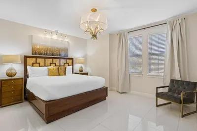 a bedroom with a large bed and a chair at Willow Cove in Orlando