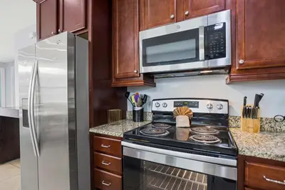 a kitchen with a stove and a microwave at Willow Cove in Orlando