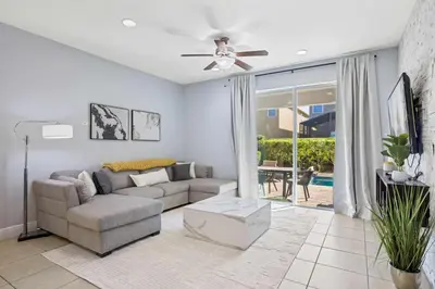 a living room with a couch and a ceiling fan at Willow Cove in Orlando