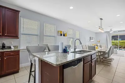 a kitchen with a counter top and a dining room at Willow Cove in Orlando