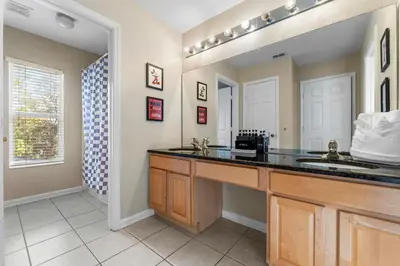 a kitchen with a counter and a sink and a window at The Colorful Cove in Orlando