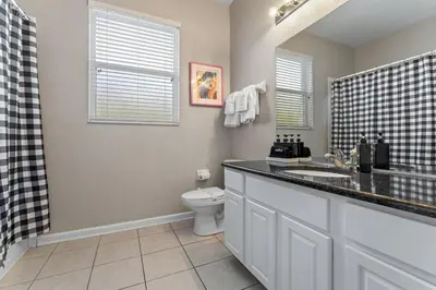 a bathroom with a sink and a toilet in it at The Colorful Cove in Orlando