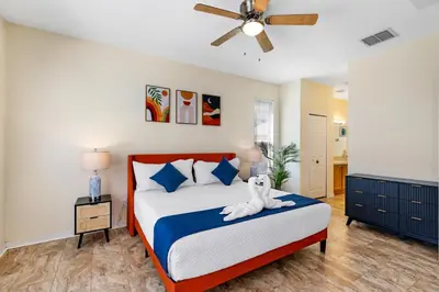 a bedroom with a bed with a stuffed animal on it at Luxury Emerald Island Resort Villa with Stunning Pool Deck and Lake View Near Disney in Kissimmee